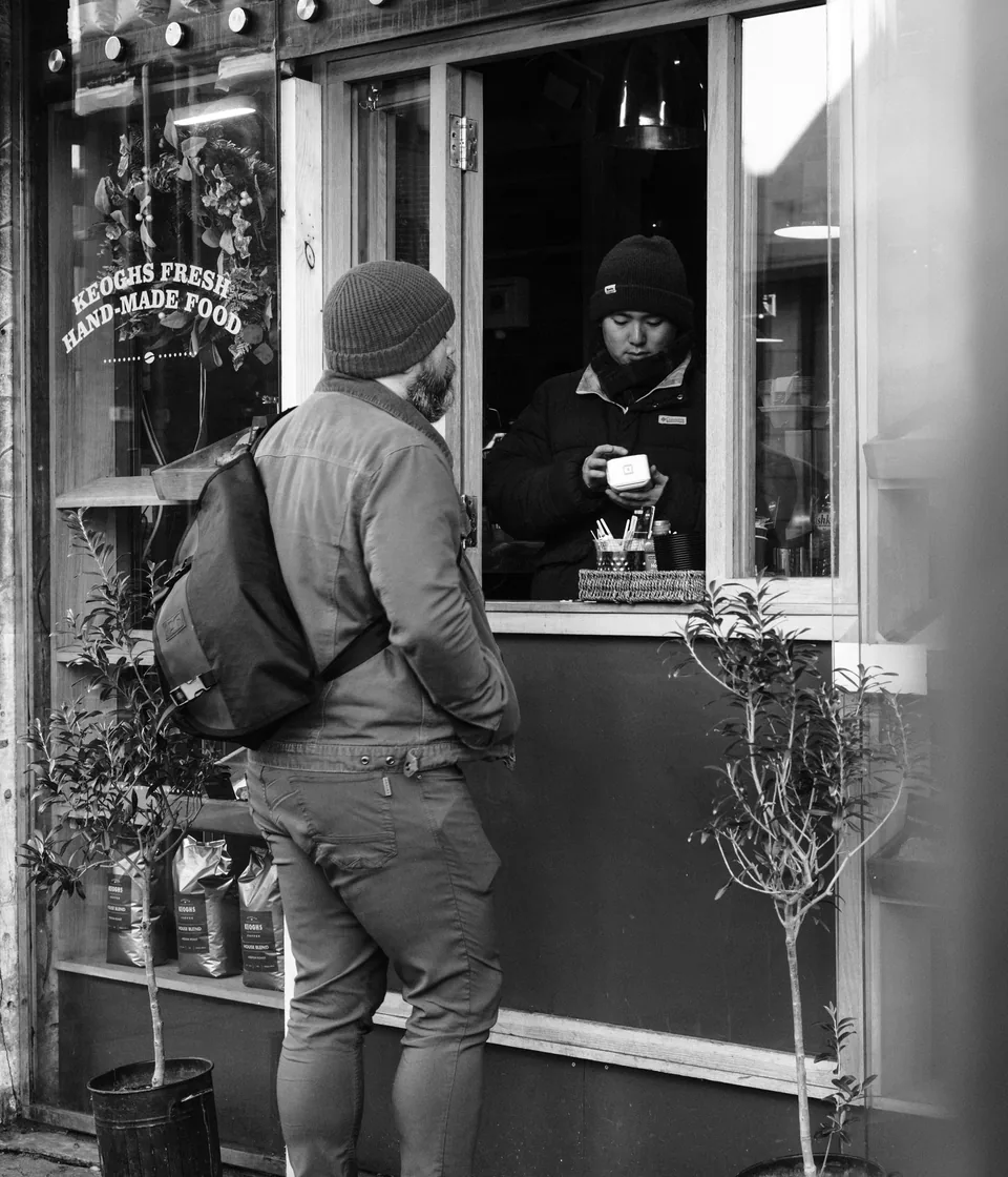 Local business owner working at the counter of a neighborhood shop